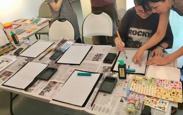 Roosevelt Island's Cherry Blossom Festival Draws Thousands Japanese style ink painting being taught during the Cherry Blossom Festival